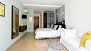 Seville Apartment - The sleeping area has twin beds placed together and a large wardrobe.