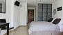 Seville Apartment - The sleeping area has twin beds placed together and a large wardrobe.