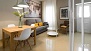 Seville Apartment - Dining area with table and chairs. The window faces the patio of the house.